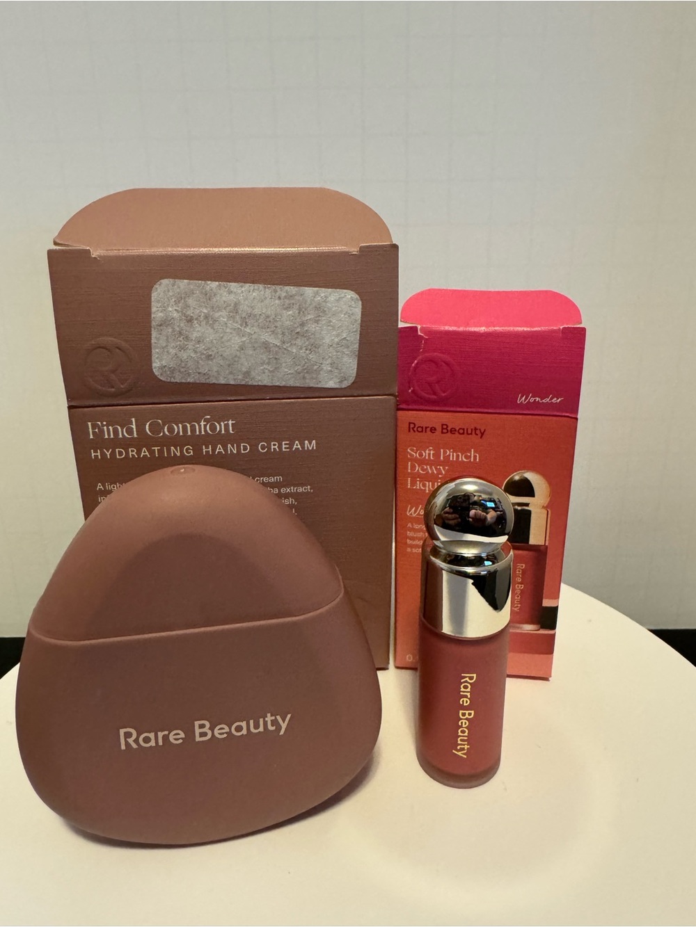 Rare Beauty Lip Gloss & Case Set in Rose Pink and hand cream